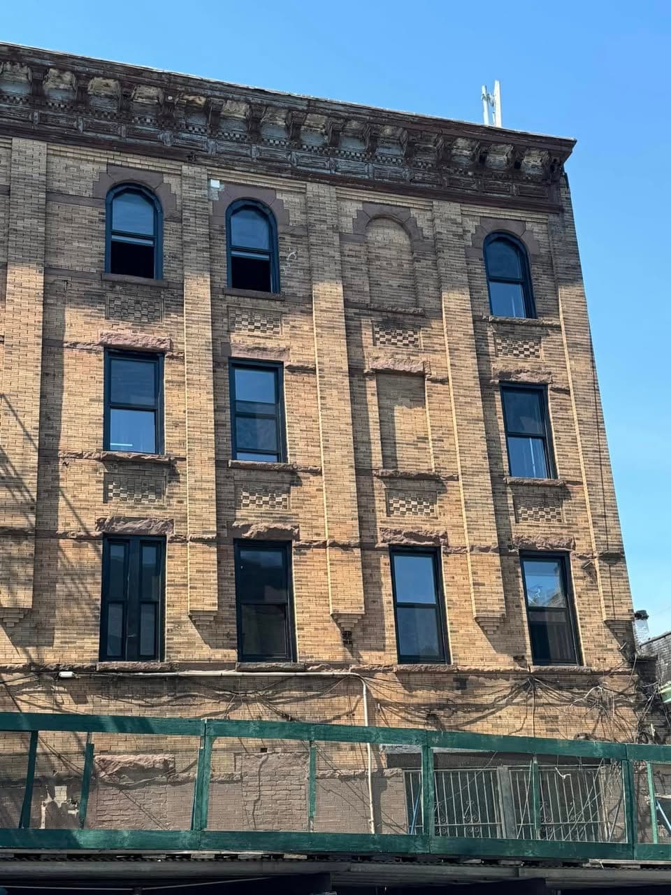 Multi-story Brooklyn brick building lined with windows