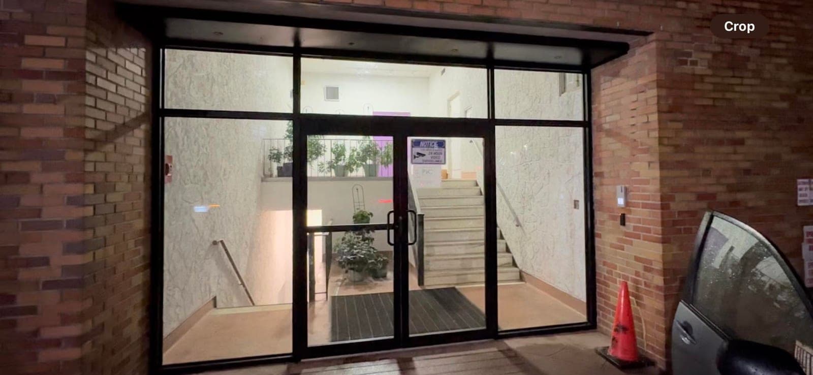 Commercial storefront with black-framed glass windows and entry door
