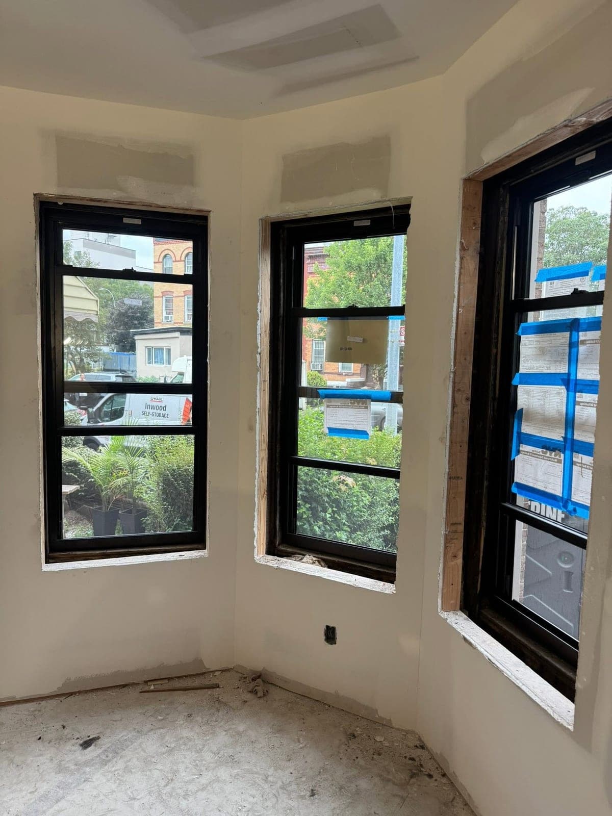 Residential bay window with multiple panes being repaired and replaced